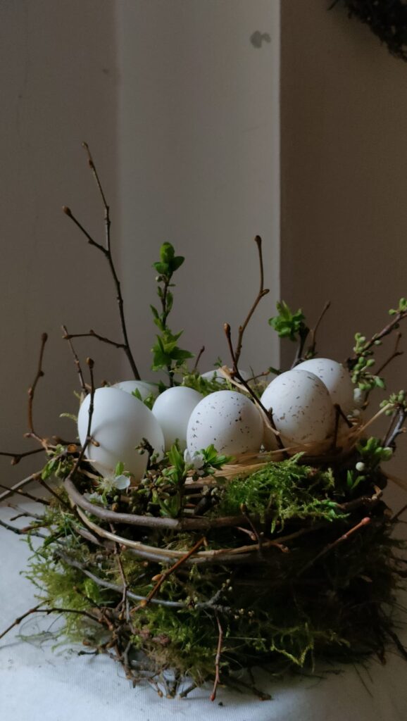 Nido di rami con uova dipinte per un Easter gardening semplice e raffinato